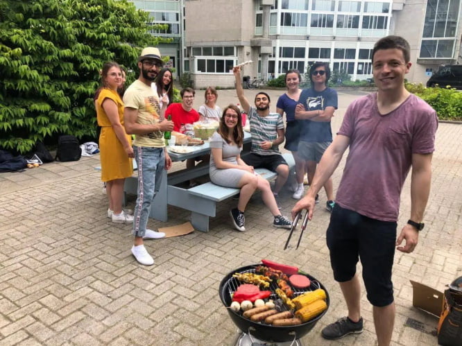 A group of members learning Dutch while having fun during a barbecue event